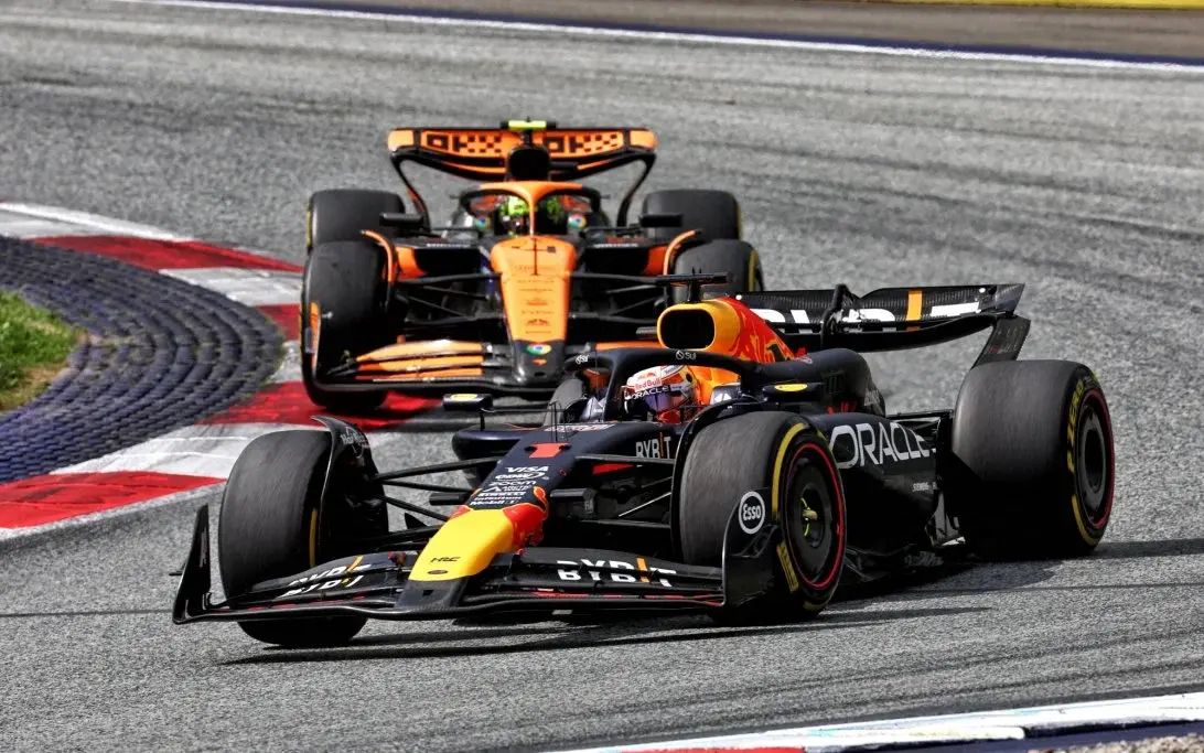 McLaren F1 car in papaya orange livery leading race